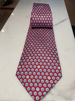 Full-length view of tie laid flat showing overall pattern and color