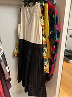 Front view of cream and black Marni dress with pleated skirt