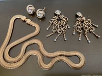 Overall view of necklace and two pairs of earrings