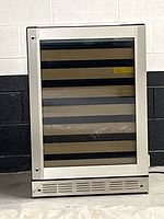 Front view of the GE wine fridge showing stainless steel frame and wood shelving inside glass door.