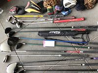 Overhead image of seven steel shaft golf clubs and headcovers