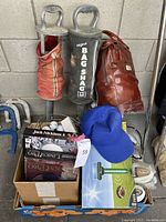 Photo of golf bag shags, boxed golf balls, PC games, blue cap and solar mole repellant device