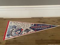 Full view of the 1993 Toronto Blue Jays World Series Champions pennant with team logos and printed autographs.