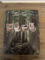 Front of souvenir booklet showing four 1993 Canadian postage stamps affixed on a green forest background with the title 'Collection of the Postage Stamps of Canada' in English and French.