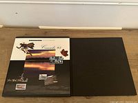 Closed black album with decorated cover titled 'Canada 95' containing the stamp collection
