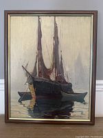 Full frontal photo of the framed oil painting showing a boat with sails on calm water, signature visible. Minor surface wear.