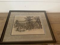 Framed etching showing full artwork with people overlooking a city and trees in the foreground.