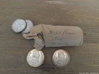Coins arranged with paper roll for reference.