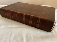 Full view of the leather bound volume closed on its front cover