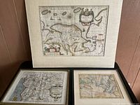 Three antique maps displayed including a large matted map of Groningen and two smaller maps