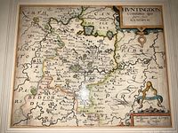 Flat lay of unframed map showing full map surface, decorative cartouches and hand coloring