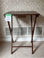 Front view of the wooden folding side table with legs extended and showing the table top surface and leg design.