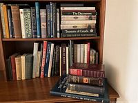 Books arranged on bookshelf showing various history, literature, and reference titles focusing on Canadian and world history.