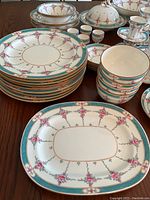 Full lot overview showing oval tray, comport, cups, saucers, bowls and stacks of plates