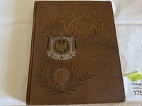 Front cover of the brown hardcover book titled 'Napoleon's Victories' featuring embossed gold text and an illustrated eagle emblem with surrounding laurel wreaths and decorative elements.