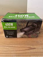Front view of the box showing product name 400W Metal Fog Machine with image of the fog machine unit.