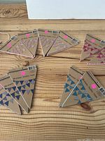 Multiple Recollections craft banner packs arranged on table showing blue and pink triangular flags in packaging with 24 sheets each.