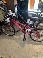 Photo of the pink women's Magna bike next to the blue men's Huffy bike showing the full side profile of both bikes