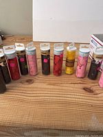 Front long shot showing 12 confetti tubes aligned horizontally with various colors and shapes visible in transparent tubes.
