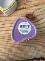 Top view of heart shaped jewelry box in light purple showing the bottom with barcode label