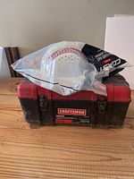 Craftsman red and black toolbox with a white hard hat packaged on top.