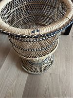 Side angle view showing the lattice rattan construction and twisted base design of the planter.