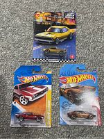 Lot of three Hot Wheels Camaro cars on cards including Boulevard Series '67 Camaro in yellow with rubber wheels