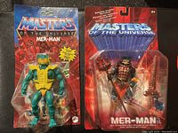 Two Mer-Man action figures from Masters of the Universe in original packaging, showing front view with figures and accessories visible.
