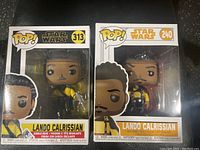 Two boxed Funko Pop Star Wars figures of Lando Calrissian numbered 313 and 240.
