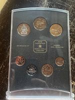 Front view of the full set of eight coins in black protective case with clear cover showing all coins and Royal Canadian Mint label.