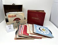 Overall view of the vinyl record collection with the storage case and red album binder visible