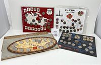 Four boxed sets of Canadian commemorative coins arranged side by side on a white surface
