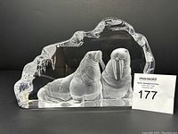 Front view of lead crystal sculpture showing two etched walruses with smooth and frosted crystal detailing, set within an irregular ice-like form.
