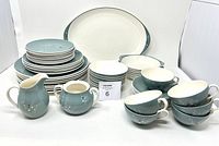 Full set of Royal Doulton Spindrift vintage dishes including plates in multiple sizes, teacups, saucers, creamer, sugar bowl, and serving platter arranged together for a comprehensive view.