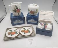Full set of Royal Worcester Evesham items arranged on boxes and tabletop showing cream jug, sugar bowl with lid, two egg coddlers, and six coasters in box.