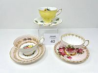 Full set of three vintage cups and saucers with varied floral and gold trim designs.