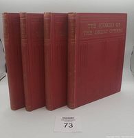 Four red hardcover books standing upright with gilt title 'The Stories of the Great Operas' on front cover visible.
