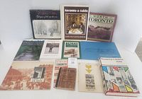 Full set of 12 Toronto-themed books and guides laid out on a flat surface showing cover art and spines, including historical and culinary titles.