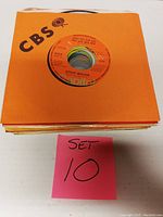 Stack of 25 records in CBS orange sleeves with visible Steve Miller Band record