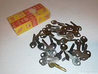 Box and loose uncut blank keys spread out, showing various key heads and metal types.