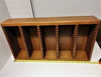 Front view of oak wood CD holder showing the 86 individual slots divided into six sections.