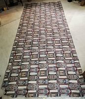 Full length view of upholstery fabric showing repeats of the jukebox pattern.