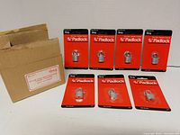 Seven new 3/4 inch mini padlocks in original sealed packaging displayed with outer box.