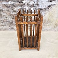 Front view of antique oak square umbrella stand showing even vertical spiked slats and oak base with good visible wood grain and patina.