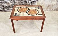 Front elevated angle of Danish teak tile top table showing abstract tile pattern and clean condition.