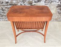 Front view showing teak top, paired grain and slatted storage bin