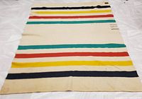 Full view of the vintage Eaton's 4 Point Trapper blanket laid out flat showing the colorful horizontal stripes and overall condition with visible stains and color pattern.