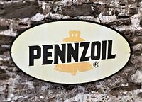 Front view of the oval-shaped Pennzoil sign with bold black text and yellow bell logo on off-white background.