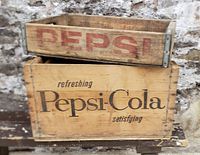 Front view of both vintage wooden Pepsi crates stacked showing branding and condition.