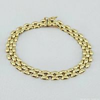 Full view of the 14K gold ladies bracelet laid flat